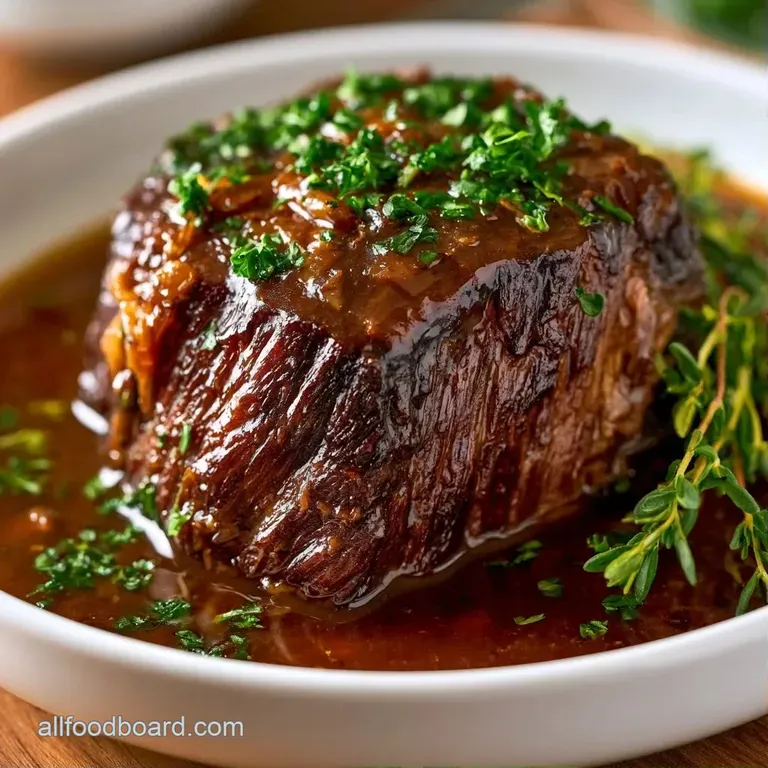 Slices of juicy beef served on a white ceramic plate with glazed carrots, baby potatoes, and a sprinkle of parsley.