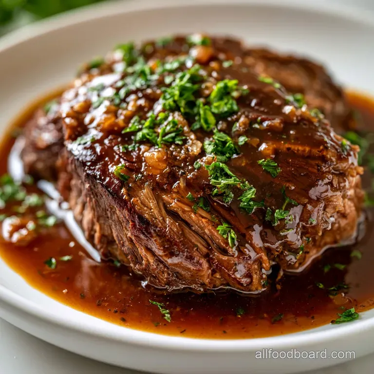 Plated tender beef medallions draped in savory brown gravy with vibrant carrots on a white porcelain dish.