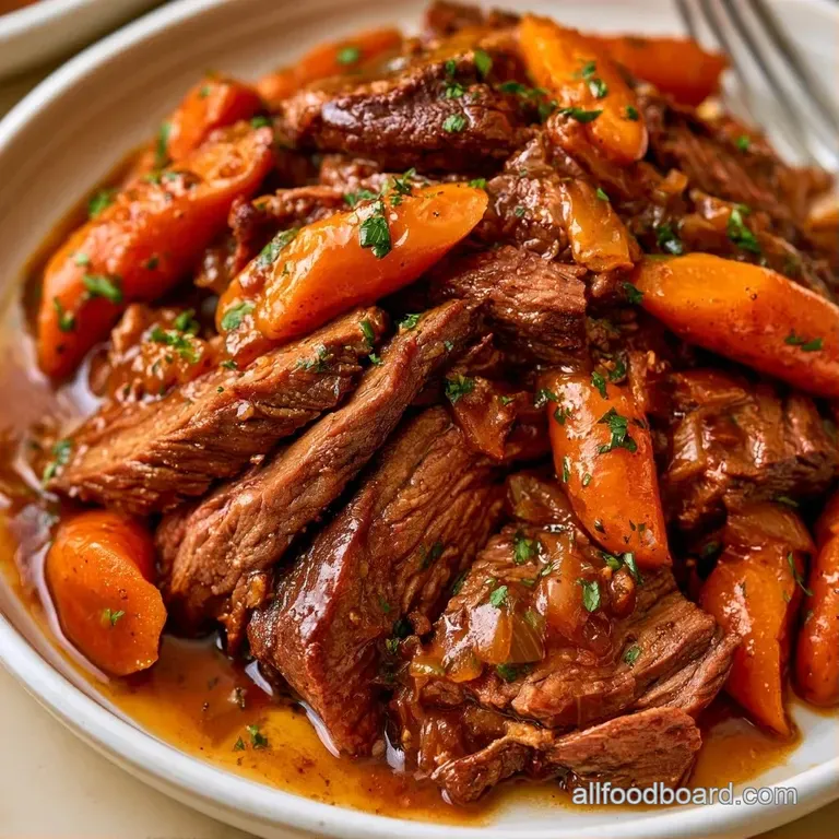 Slow-cooked meat slices paired with a fluffy potato dumpling on a white plate, drizzled in a deep brown glaze.